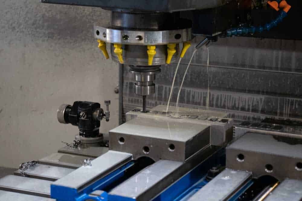 CNC vertical milling machine machining a metal part at New Tech Metals