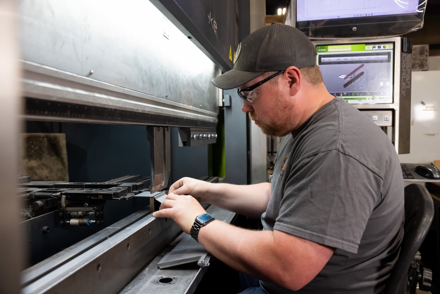 Operator forming a small part on the 5-foot Safan Darley E-Brake at New Tech Metals