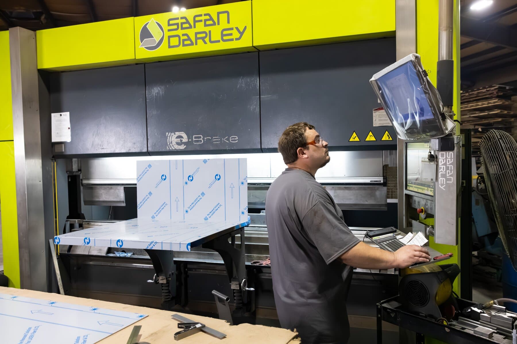 Operator forming a large stainless panel on the 10-foot Safan Darley E-Brake at New Tech Metals