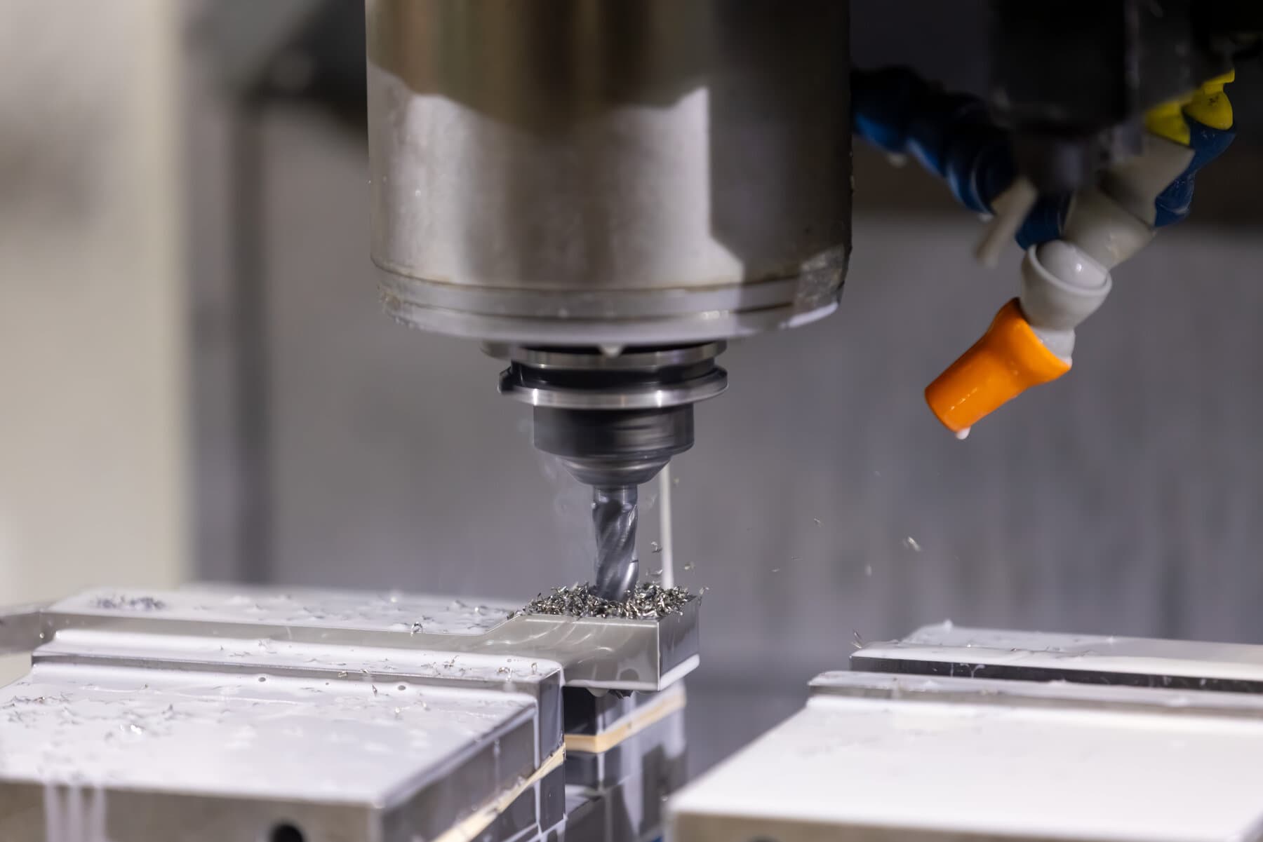 Precision CNC machining of a small part with flood coolant at New Tech Metals