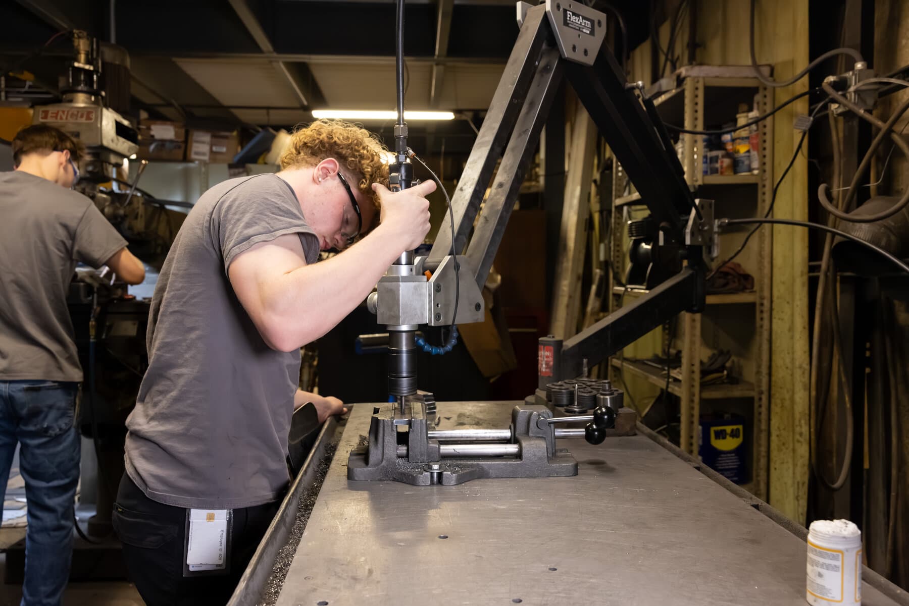 New Tech Metals machinist tapping a part on a FlexArm tapping arm