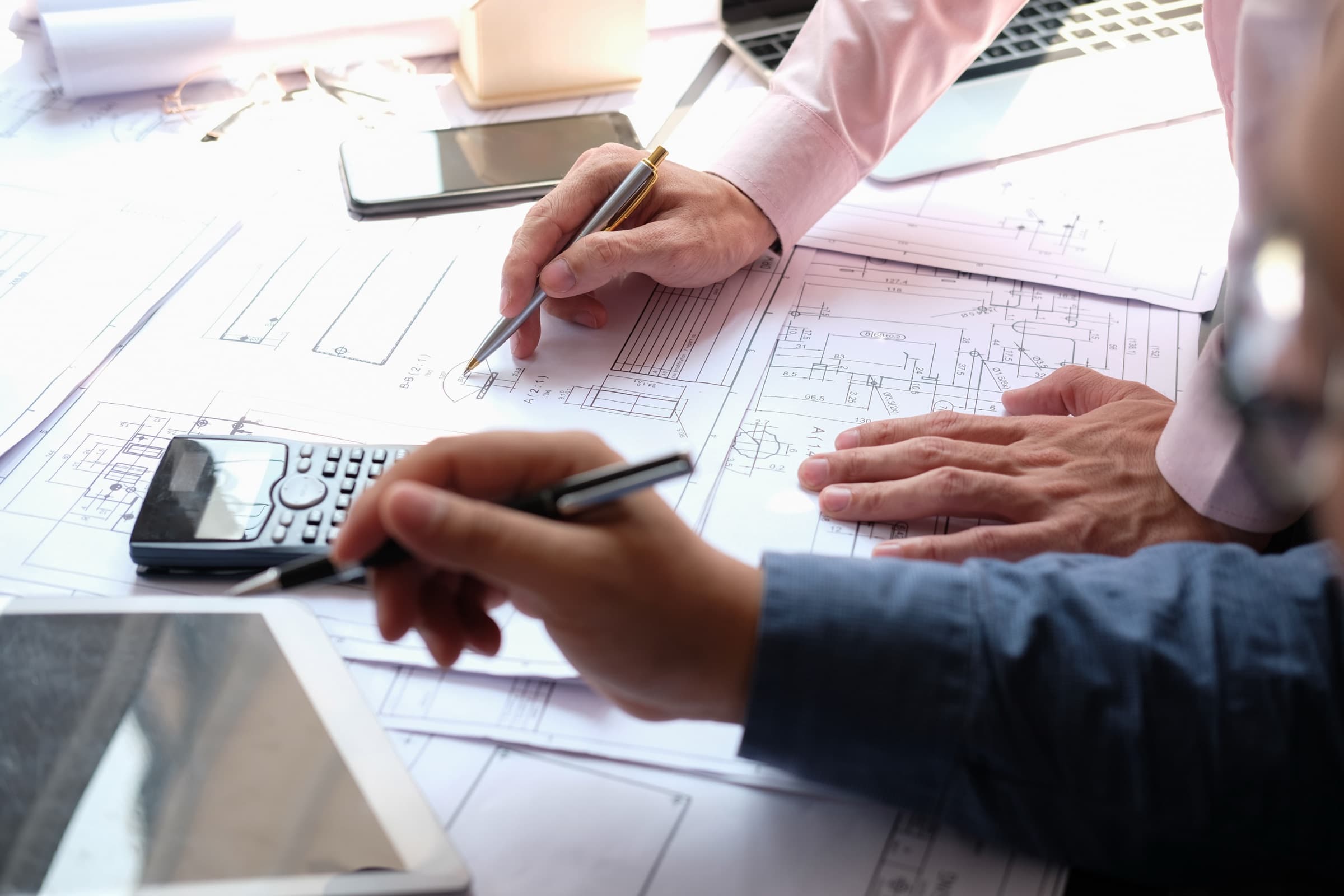 New Tech Metals team reviewing engineering drawings and part specifications during a request for quote
