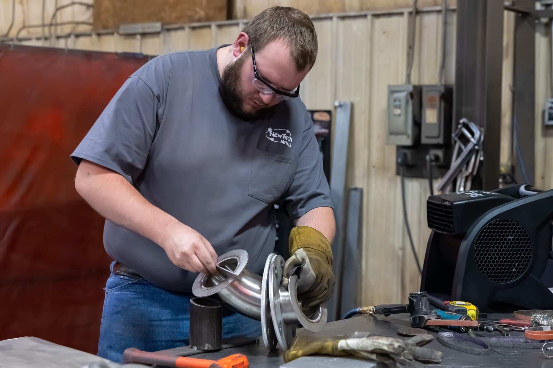 Welder finishing a stainless exhaust elbow