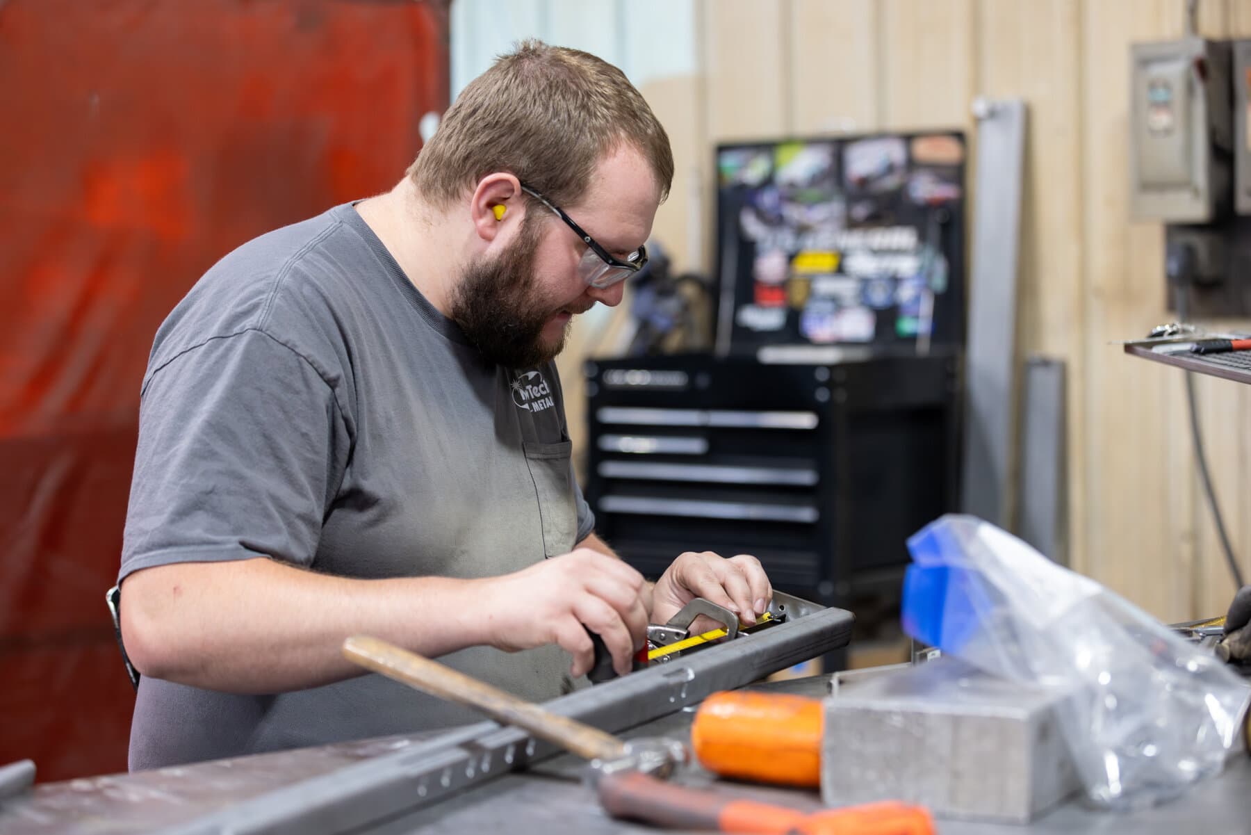 New Tech Metals fabricator measuring and laying out a part