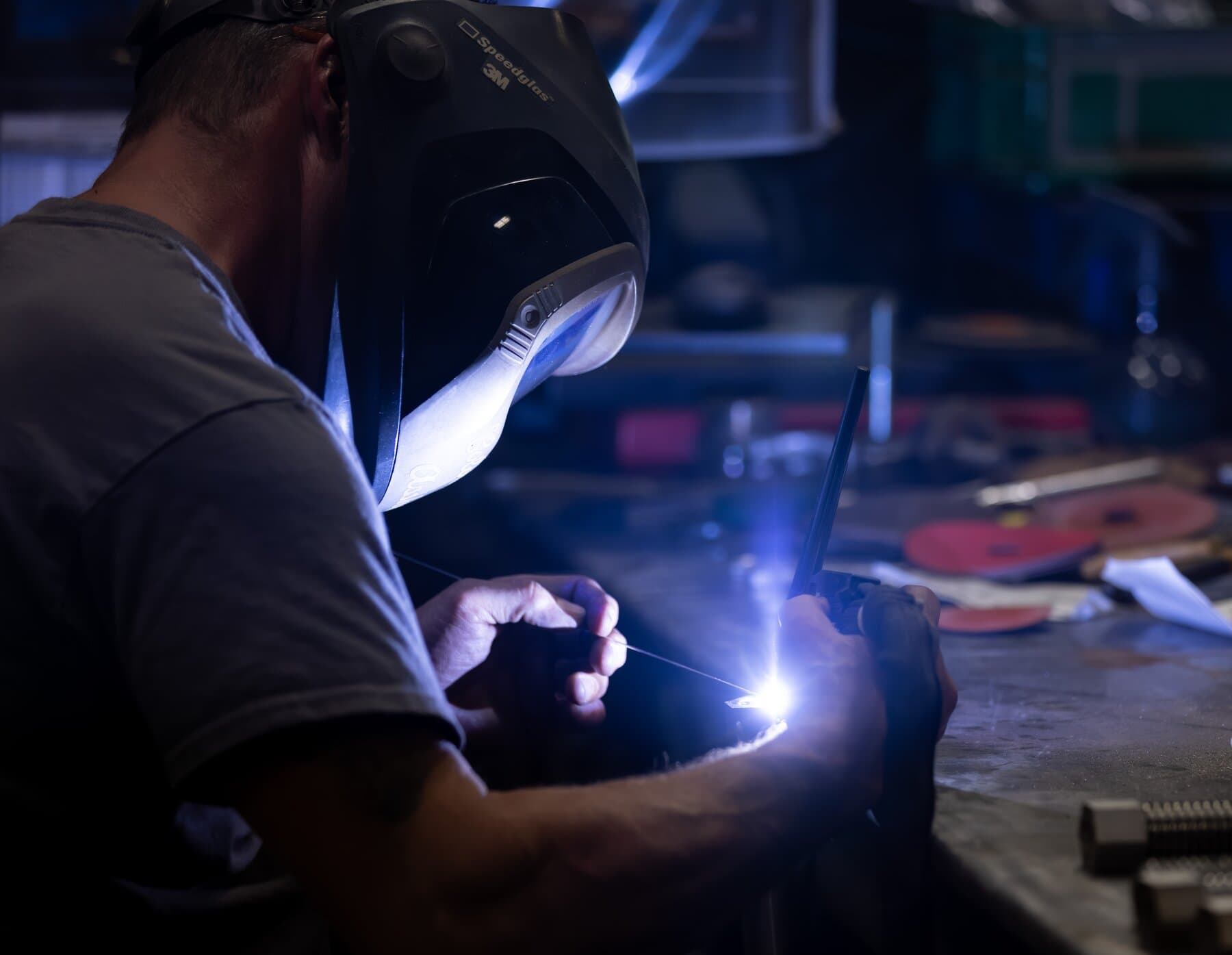Close-up of a New Tech Metals welder TIG welding a precision part