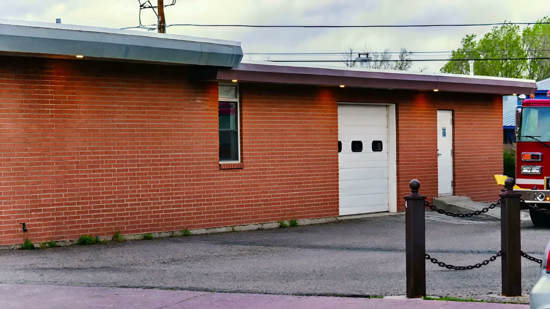 Red fire apparatus parked outside a fire station